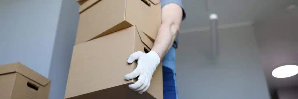 man-work-clothes-gloves-carries-cardboard-boxes-1024x342